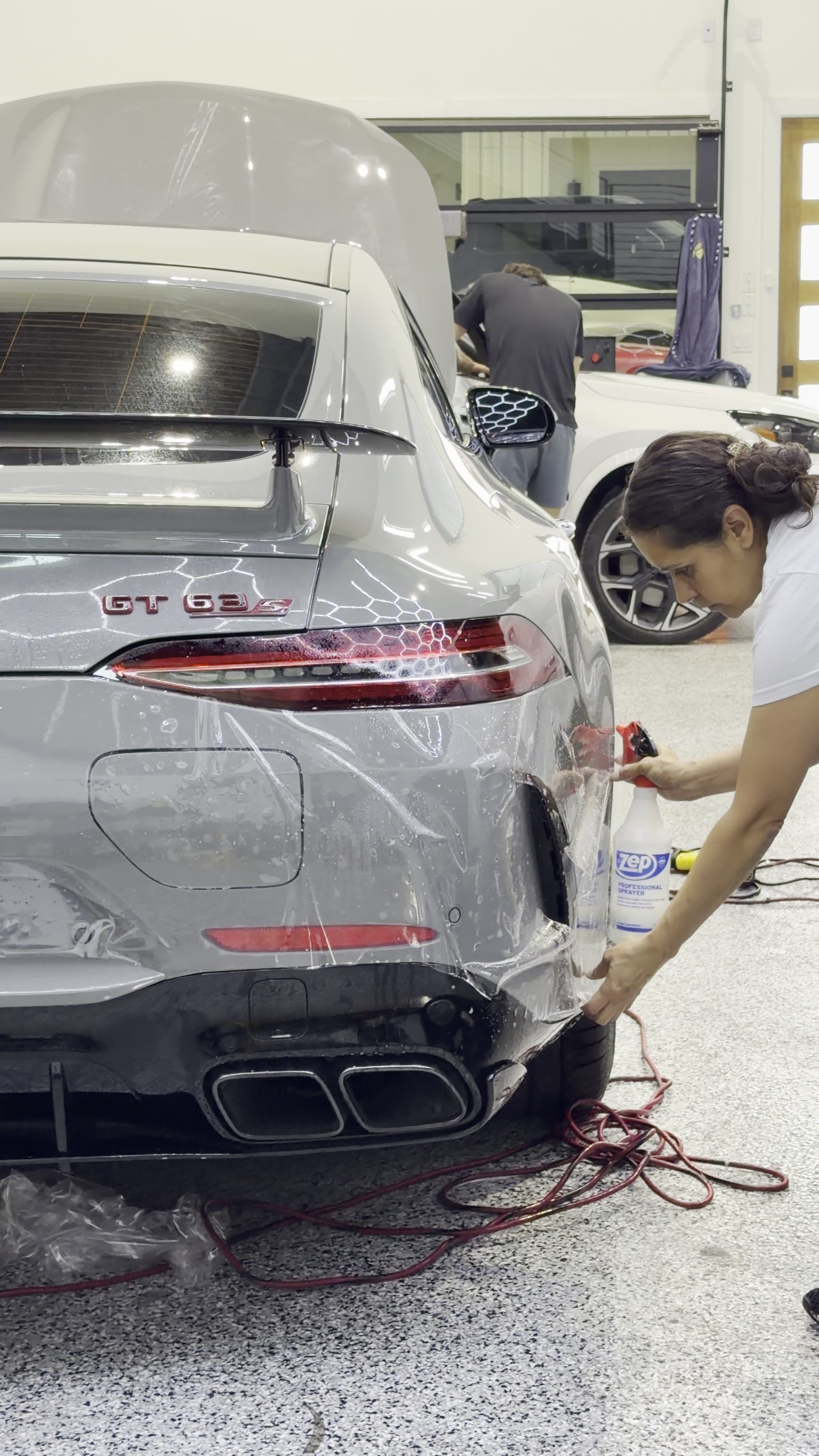 PPF installation on the rear bumper of a silver Mercedes