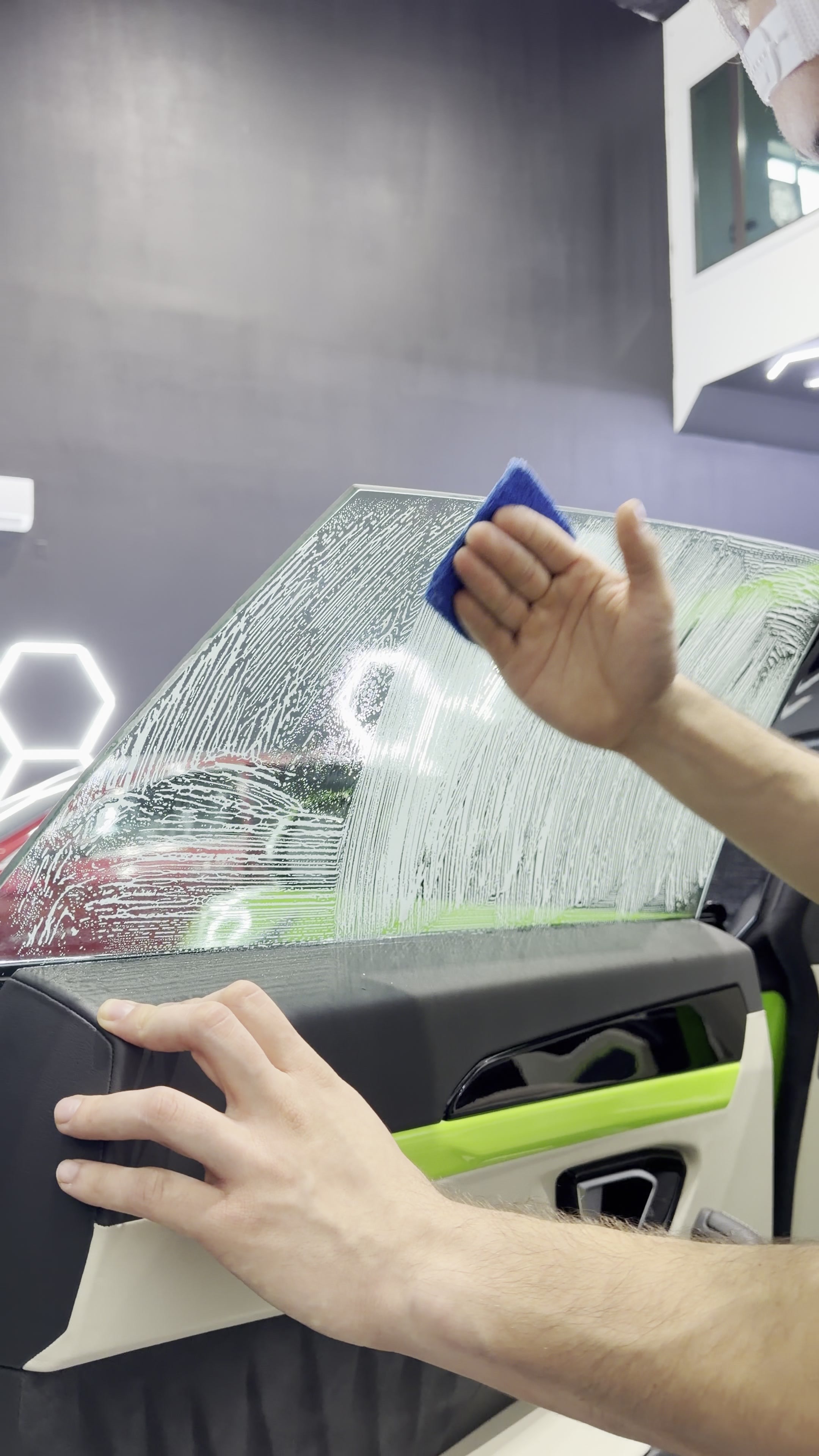 Window tint being smoothed onto vehicle glass