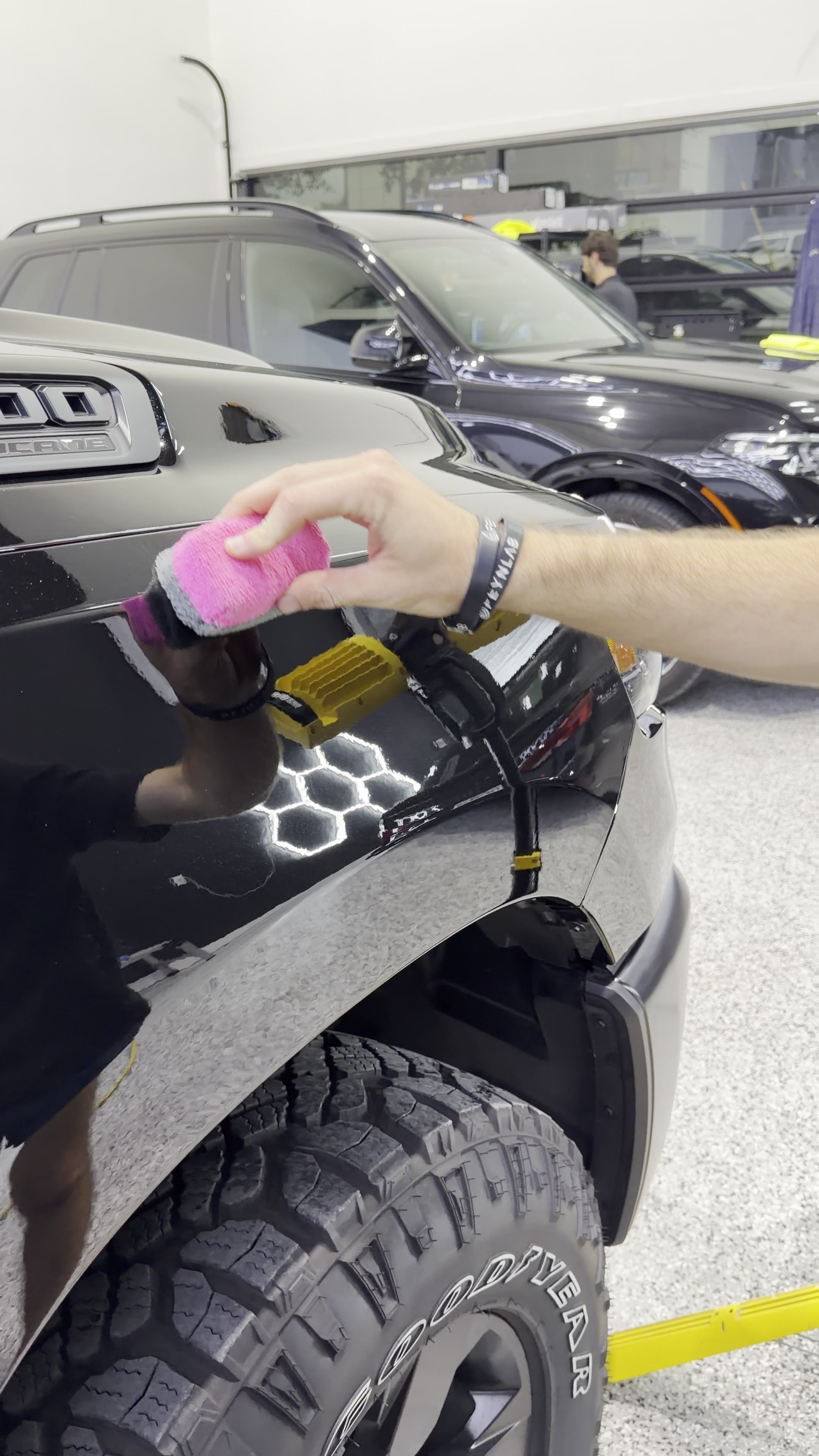 Ceramic coating applied by hand to a dark vehicle